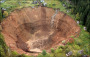 The crater that keeps swallowing up houses