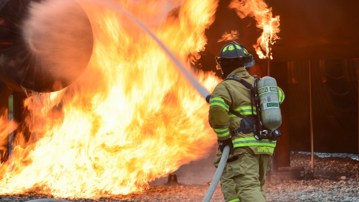 Ein Feuerwehrmann löscht einen Brand. (Symbolbild)